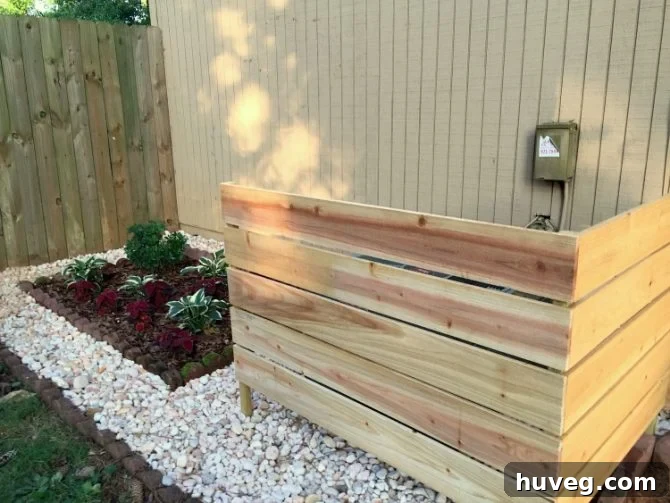 The air conditioner is hidden behind the wooden cover with enough space for airflow.