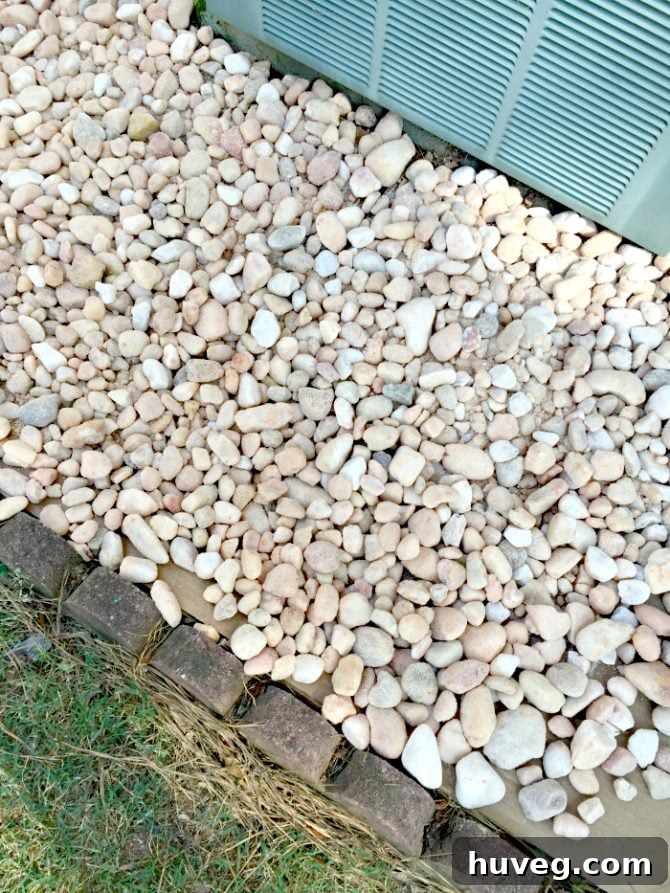 Egg rock landscaping around AC unit