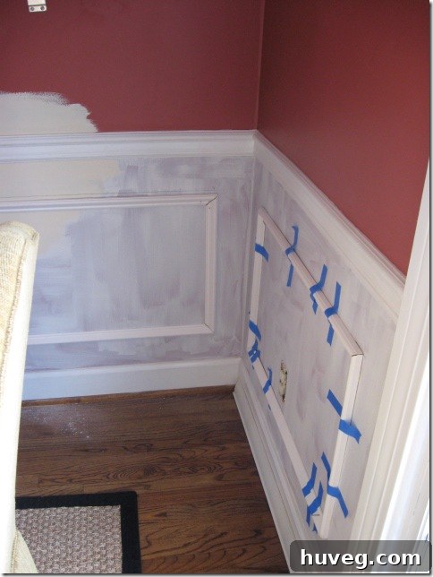 Wainscoting with picture frame molding painted for a seamless look