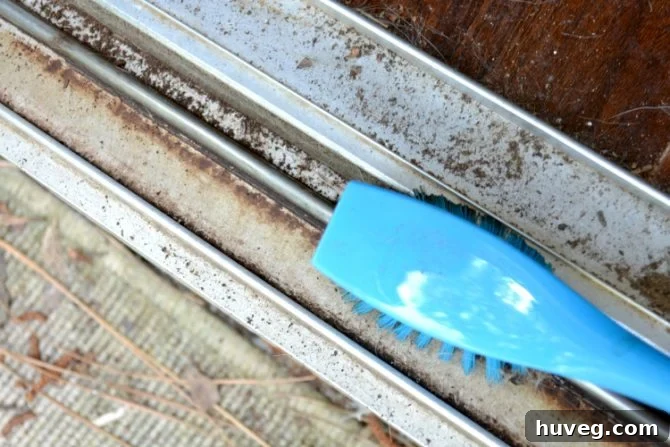 scrub dirty sliding door track