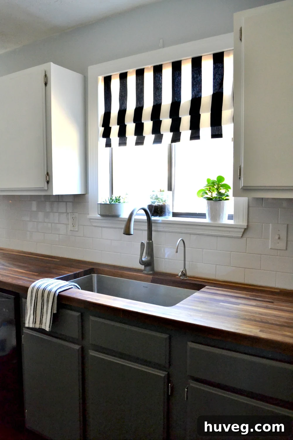 Stunning kitchen makeover featuring butcher block counters and a deep undermount sink
