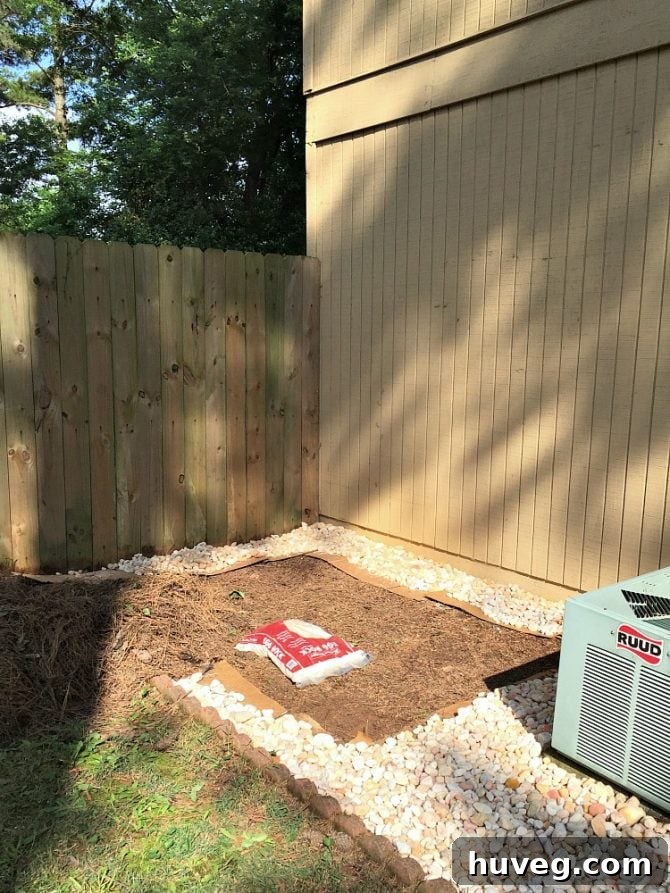 Filling in landscaping stones and establishing the garden bed around the AC unit