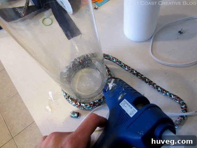 Hot glue the first rope layer to the vase