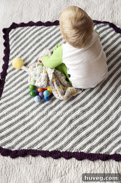 A beautifully crafted, soft knitted baby blanket by Rust and Sunshine, a heartwarming DIY project.