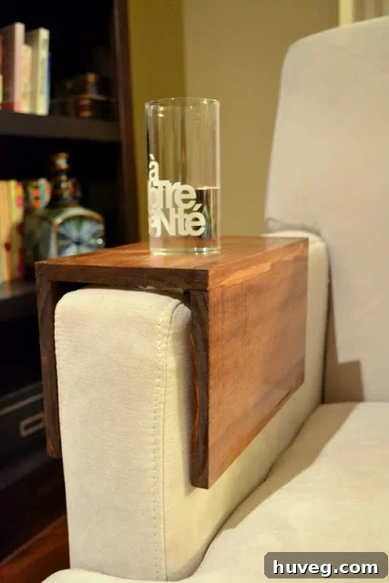 DIY wooden couch sleeve in use, holding a drink