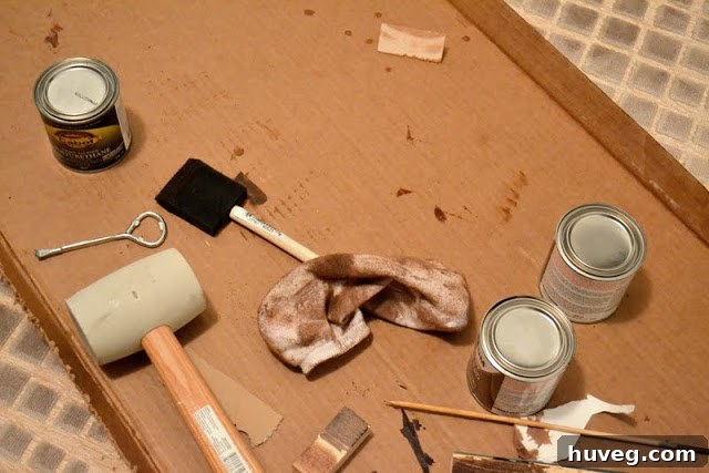 Applying stain to the wooden ampersand