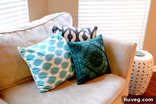 Close-up of a decorative ikat throw pillow on a sofa, adding texture and pattern.