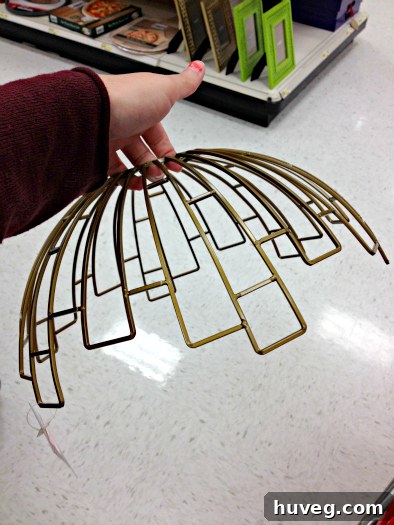 Wire bowl held upside down, ready for DIY transformation into a light fixture