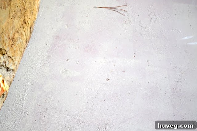 Close-up of concrete stoop showing pock marks and imperfections before repair
