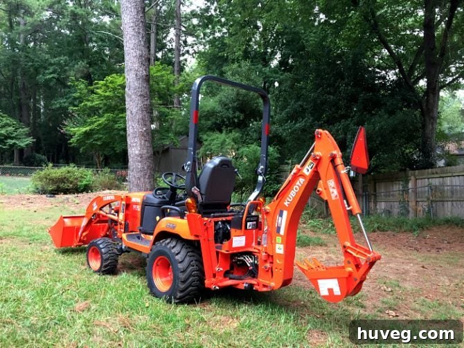 Operating a Kubota tractor loader backhoe for a backyard makeover project.