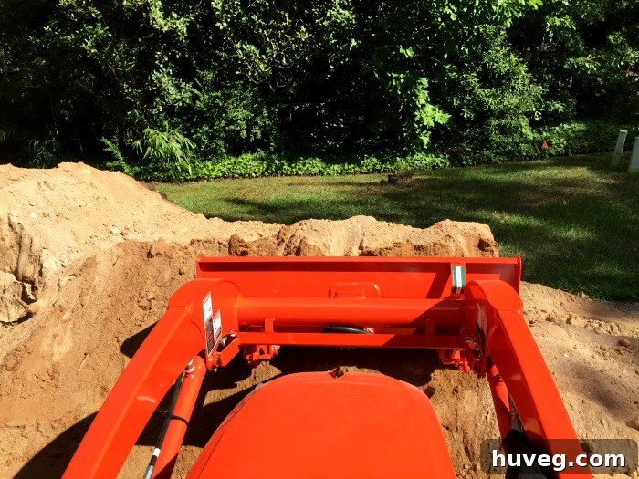Learning to operate a backhoe, demonstrating how to lift full loads of dirt with precision.
