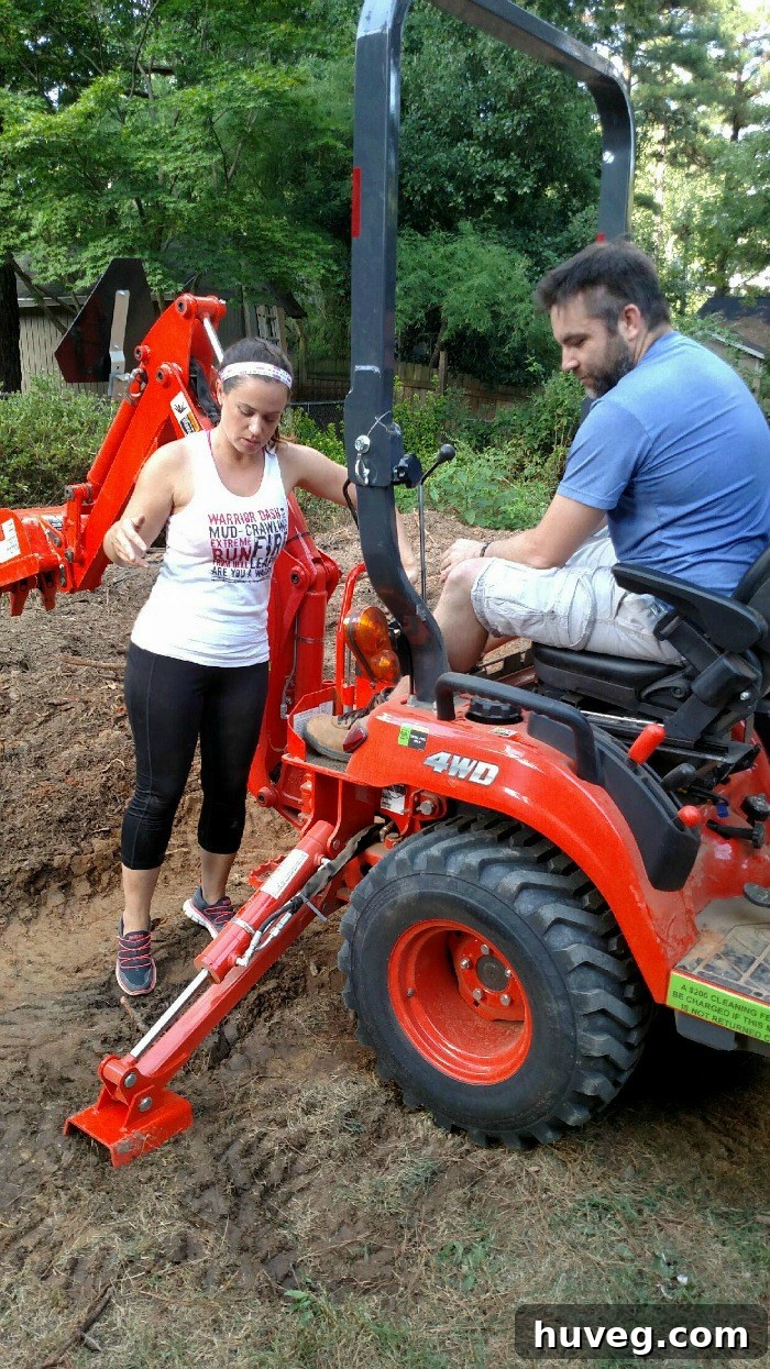 Teaching friends how to safely and effectively use a small backhoe for yard work.