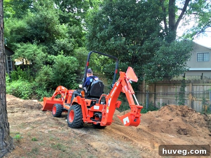 Dad expertly operating the backhoe, contributing to the yard leveling project.
