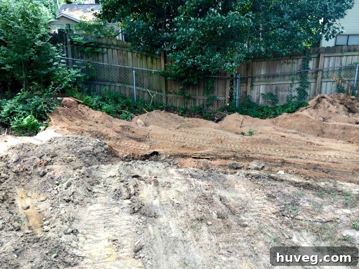 Fill dirt being strategically distributed into the backyard for leveling and sinkhole repair.