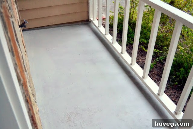 The painted stoop from a slightly different angle, showcasing the uniform gray finish and highlighting the new clean look of the entrance.